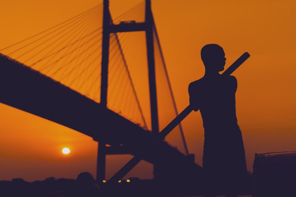 Silhouette Of Man Near A Bridge during Golden Hour